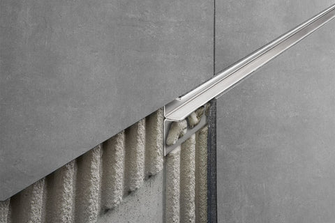 Schluter Decorative shower profile beside grey tiles